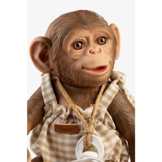 Niedliches Vinyl-Affenbaby mit kariertem Overall, 32 cm, mit beweglichen Gelenken und Bademöglichkeit.