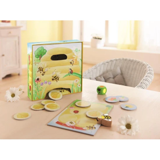 Kinder-Kooperationsspiel Bee Hanka mit einer Holzbiene und bunten Blumen.