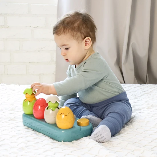 Einsteckbare Pop-up-Dinosaurier mit Knöpfen und Eiern, aus denen Dinosaurier herausspringen.