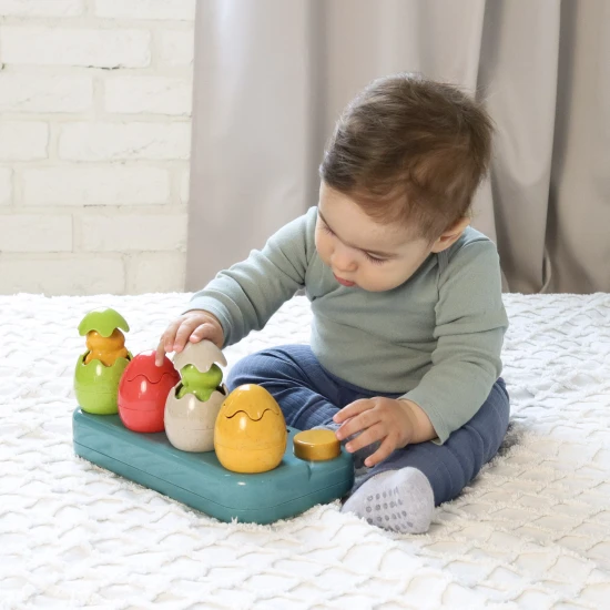 Einsteckbare Pop-up-Dinosaurier mit Knöpfen und Eiern, aus denen Dinosaurier herausspringen.