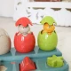 Einsteckbare Pop-up-Dinosaurier mit Knöpfen und Eiern, aus denen Dinosaurier herausspringen.